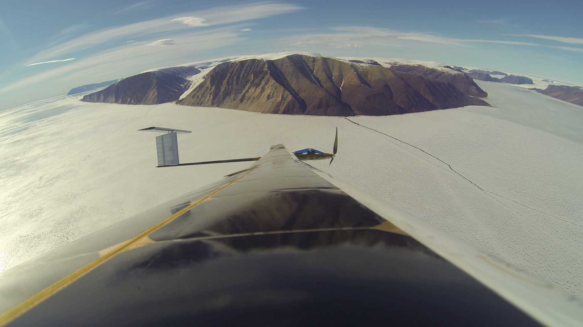 AtlantikSolar over the sea-ice in Inglefield-Bredning on its way to make a scan of Bowdoin glacier (top right).